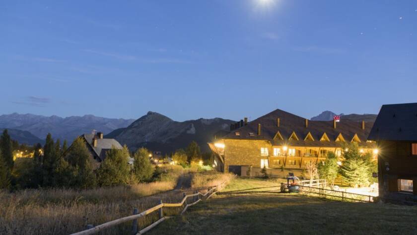 An illuminated rustic ranch venue at night, creating a cozy and inviting atmosphere for outdoor gatherings