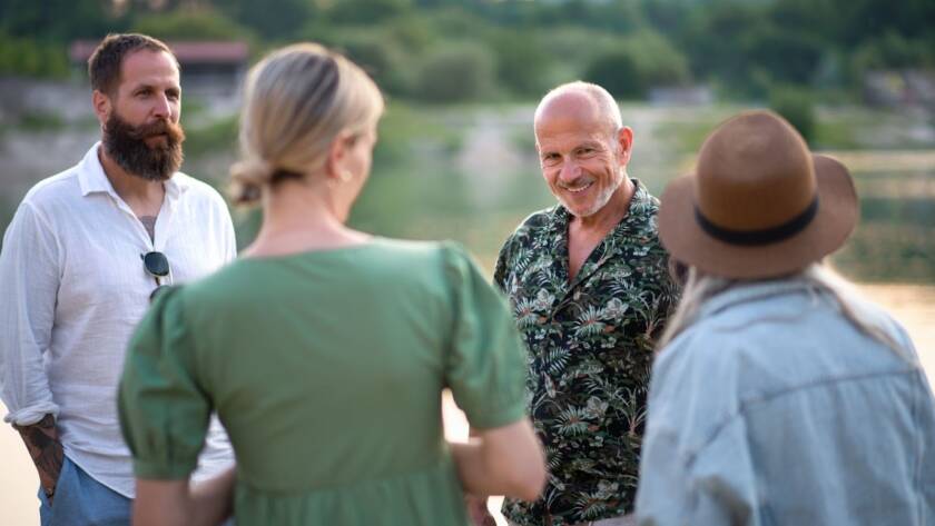 Work colleagues discussing strategies in a natural setting at a corporate retreat