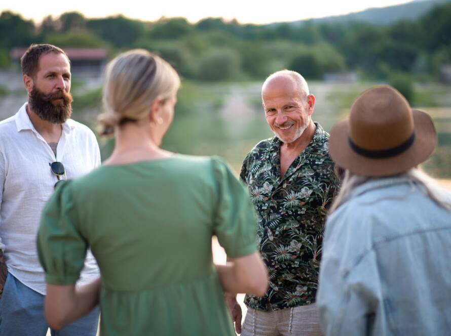 Work colleagues discussing strategies in a natural setting at a corporate retreat