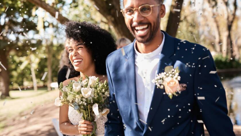 Newlyweds sharing a joyful moment during an outdoor wedding celebration