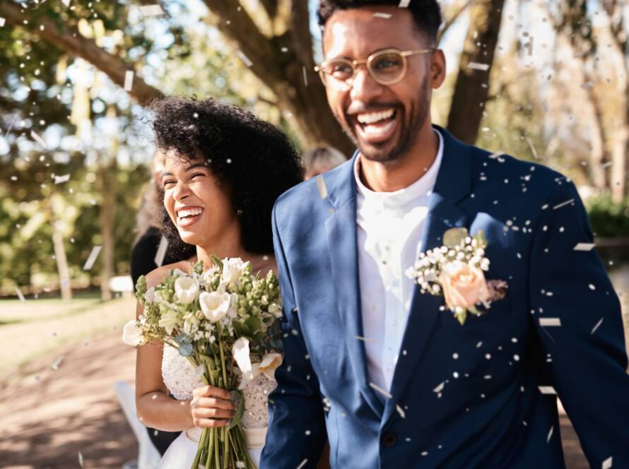 Newlyweds sharing a joyful moment during an outdoor wedding celebration